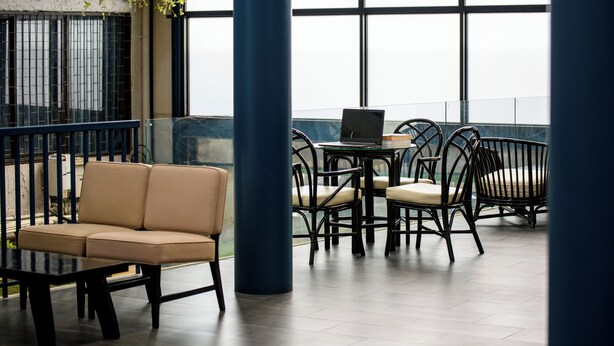 A modern outdoor seating area with a sofa, chairs, and a table. - Stay Wanglang (Bangkok)