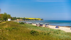 A beach with tents and people.