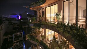 A modern building with large windows and balconies, surrounded by greenery. - CityHouse VIBE City Oasis (Ho Chi Minh City)