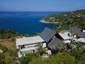 Enjoy a scenic ocean view from this multi-level property surrounded by lush greenery and featuring a swimming pool.