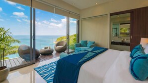 A modern bedroom with a large bed, a view of the ocean, and a balcony with wicker furniture. - Villa Samira by Elite Havens (Kamala)