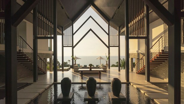 A modern interior with a view of the sea, featuring a central seating area and a water feature. - Villa Samira by Elite Havens (Kamala)