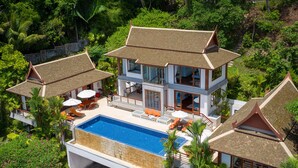 A two-story house with a swimming pool, surrounded by lush greenery and palm trees. - Baan Bon Khao (Choeng Thale)