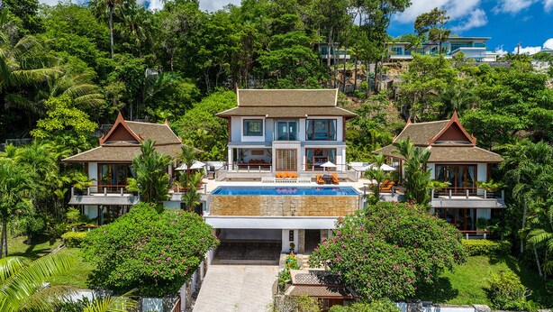 A resort with a central building featuring a swimming pool, surrounded by lush greenery and multiple smaller structures. - Baan Bon Khao (Choeng Thale)