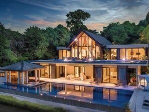 A modern two-story house with a large balcony, a swimming pool, and a lush green forest backdrop. - Naam Sawan (Pa Klok)