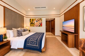 Une chambre d’hôtel moderne avec un grand lit, un téléviseur à écran plat et un tableau au mur.