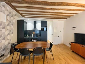 A modern kitchen with a dining area.