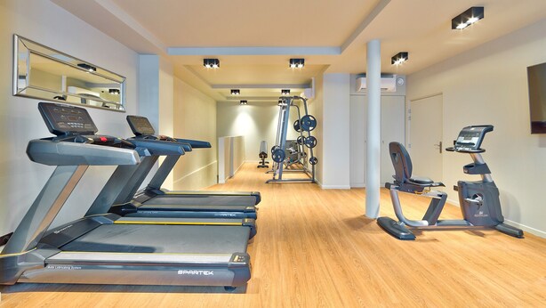 A gym with treadmills, a stationary bike, and weight machines.