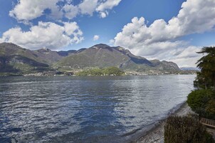 A lake with mountains in the background and a clear sky.