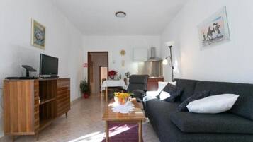 Apartment (One-Bedroom Apartment with Balcony) | Living room | 25-inch flat-screen TV with cable channels, TV