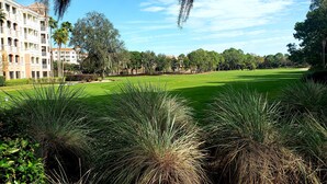 A golf course with a building in the background. - Marriott Grande Vista Deluxe Studio Luxury Resort April 12-19 25 Sat Check-in (Orlando)