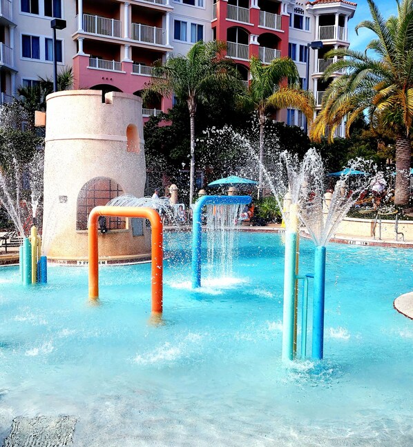 A water park with multiple water jets and a pool.