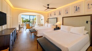A hotel room with two beds, a TV, a desk, and a balcony with chairs. - Ocean El Faro - Privilege RoofTop Junior Suite Pool view (Punta Cana)