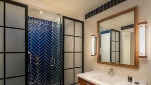 A modern bathroom with a shower, white sink, and a large mirror. - Ocean El Faro - Privilege RoofTop Junior Suite Pool view (Punta Cana)