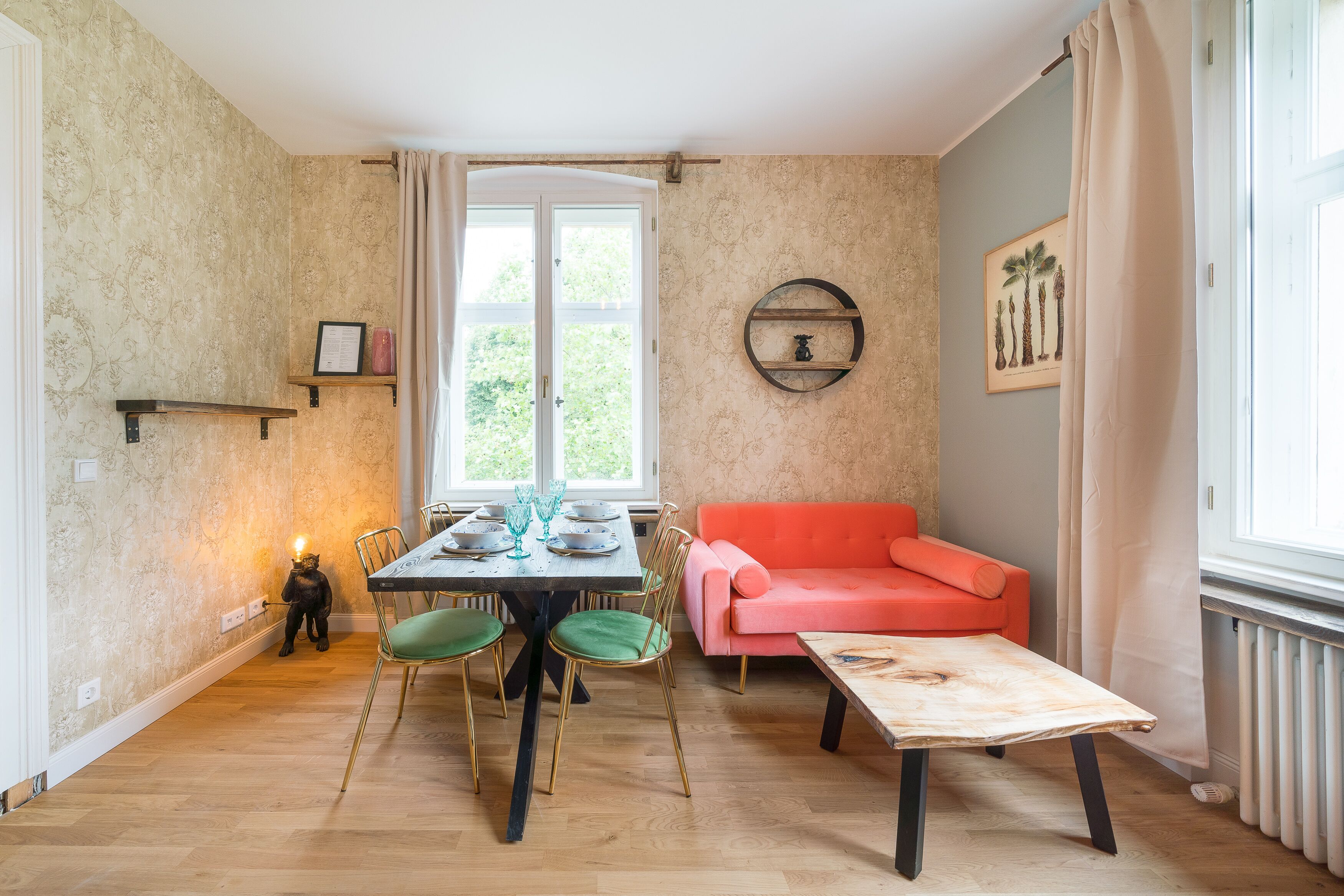 A dining area with a table, chairs, and a sofa.