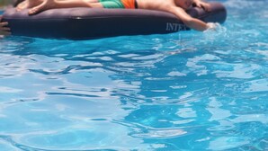 A person lying on an inflatable float in a swimming pool. - Charming 4-bed House in Pyrgetos (Tempi)