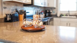 A kitchen counter with two glass jars containing food items, a coffee maker, and a toaster.