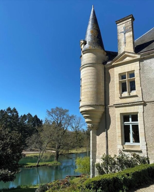 A historic building with a prominent tower and a large window.