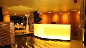 A hotel reception area with a modern design, featuring a reception desk, seating area, and a visible sign for 'BRIANNA RESIDENCE'. - Spacious luxury apartment with 180° ocean view,  pool, seafront beach (Parede)