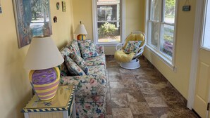 A room with a sofa, a chair, a lamp, and a window. - Pet Friendly Downtown Rehoboth Beach House (Rehoboth Beach)