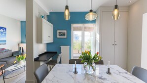A modern kitchen with a marble countertop, two pendant lights, and a view of the outside through a window. - LA TERRASSE DU PORT AP4212 (Niza)
