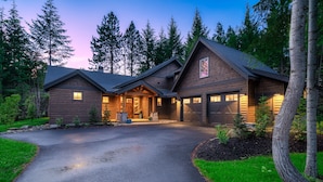 A log cabin with a stone foundation, a front porch, and a garage. - Beautiful Suncadia House With Two Master Bedrooms and plenty of space for kids!  (Cle Elum)