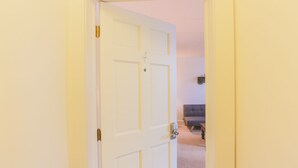 A closed white door with a brass handle and a lock. - Sleeps 4 Fully Equipped Apartment Near Golf Courses (Corry)