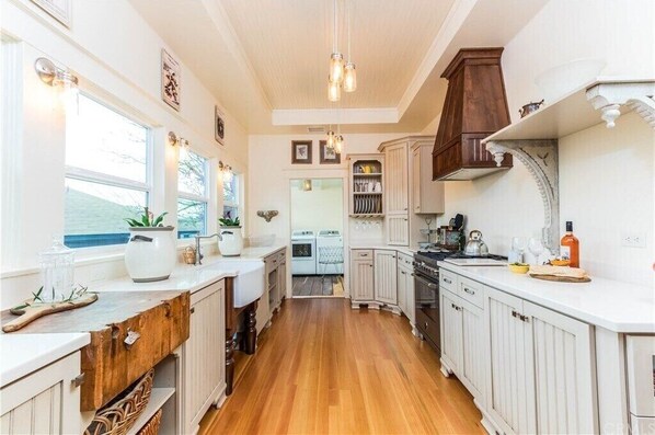 Enjoy cooking in this well-equipped kitchen with a central island, oven, and range hood.
