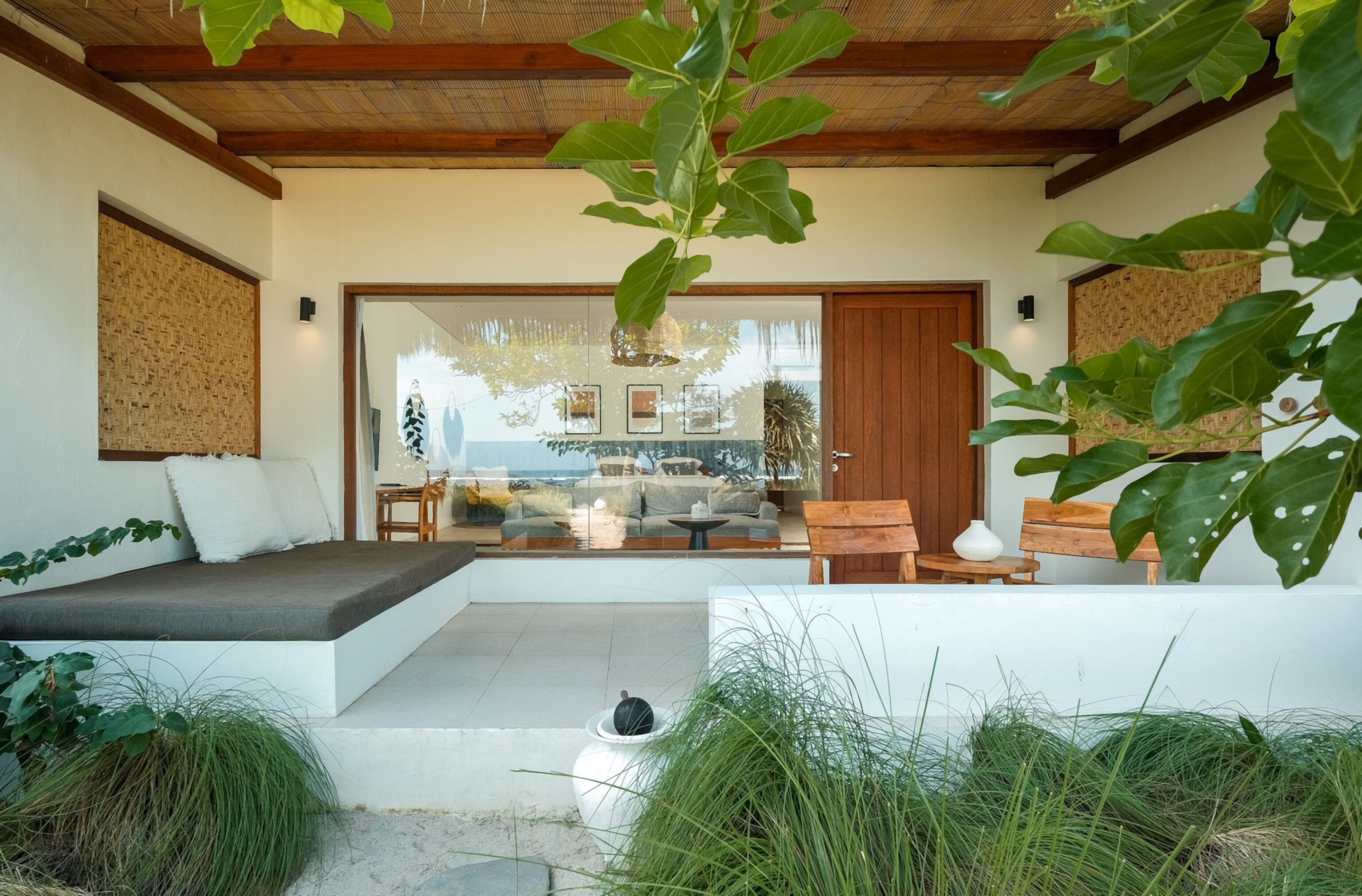 A modern outdoor seating area with a sofa, chairs, and a table.