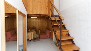 A wooden interior with a staircase, a sofa, and a small dining area. - Lapad View (Dubrovnik)