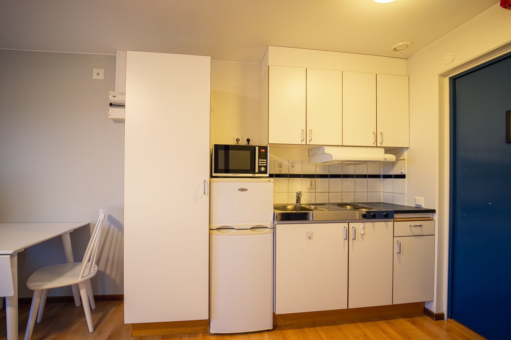 mini-fridge, stovetop, cookware/dishes/utensils, cleaning supplies