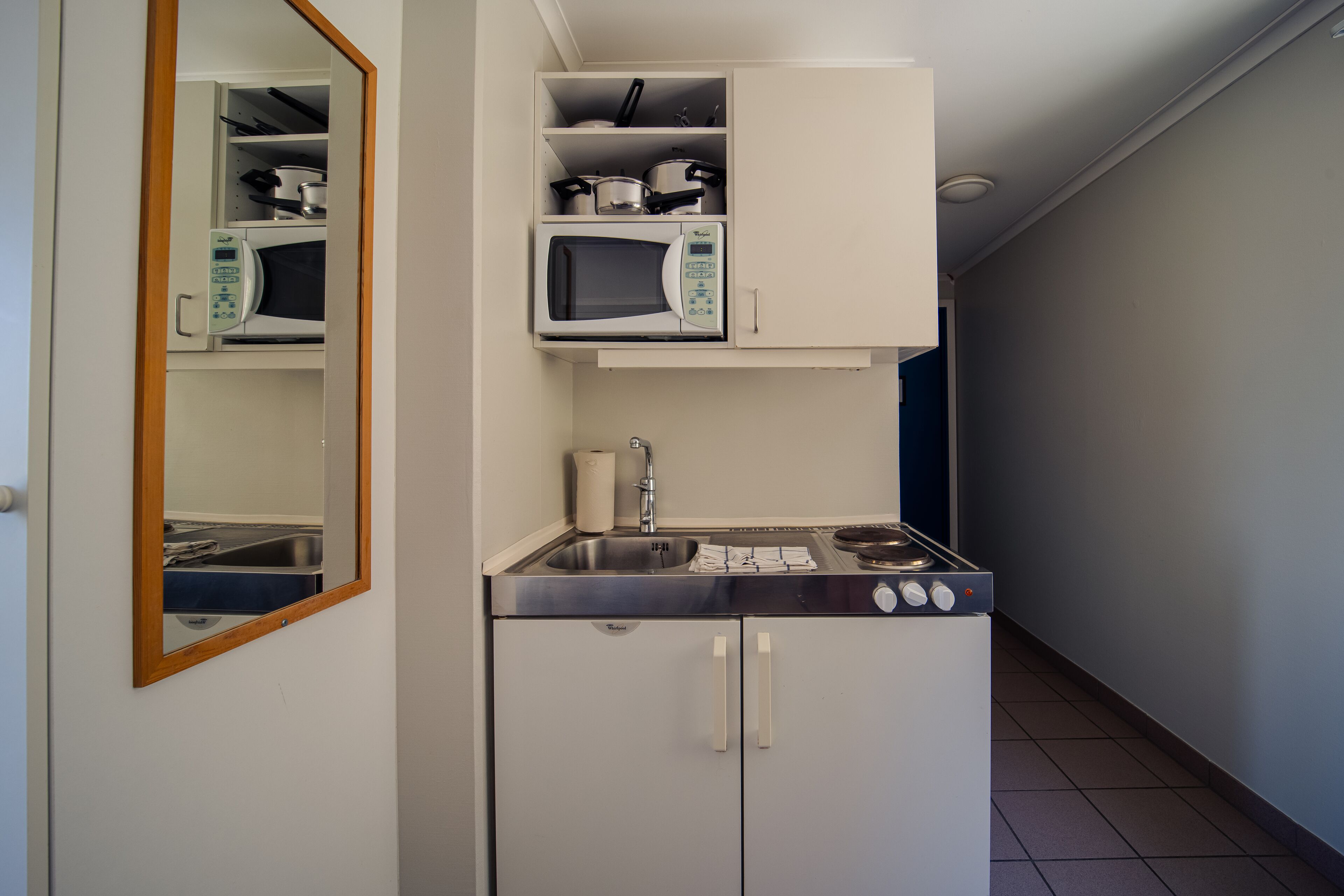 studio | private kitchen | mini-fridge, stovetop, cookware/dishes/utensils, cleaning supplies