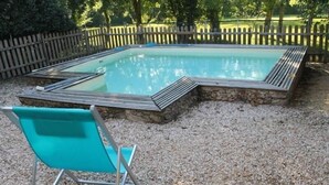 A rectangular swimming pool with a stone border and a metal deck. - Charming Renovated House with Private Pool in Saint-Christophe-du-Ligneron (Saint-Christophe-du-Ligneron)