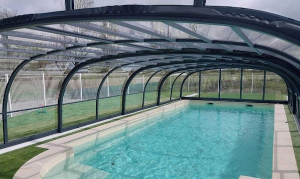 A covered swimming pool with a clear view of the surrounding area.