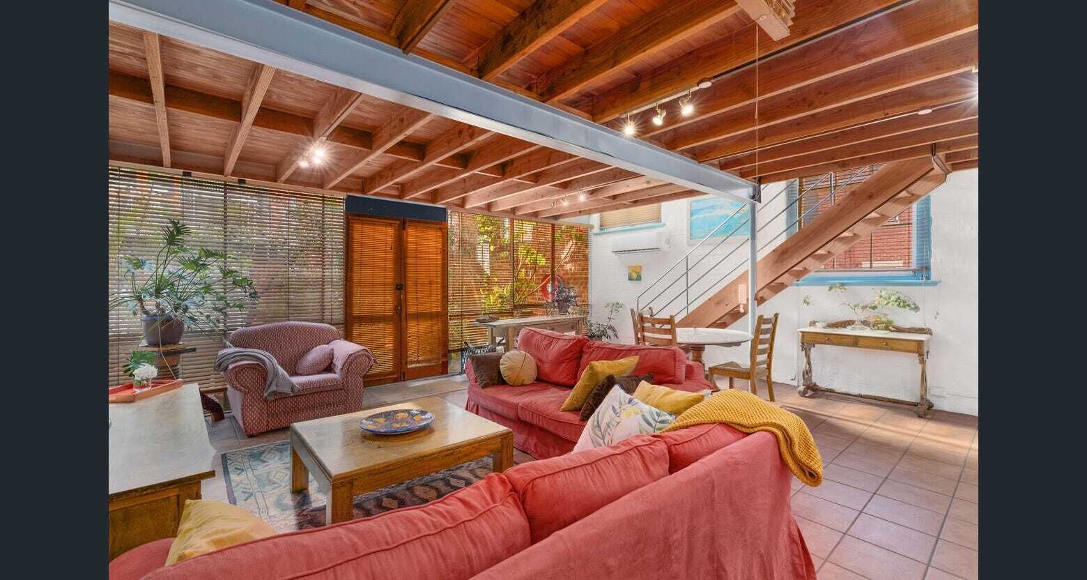 Unique loft style, three-level CBD apartment in leafy open air atrium