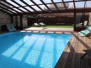 A swimming pool with a wooden deck and lounge chairs. - 18th Century Lodge, Sleeps 10 (Les Herbiers)