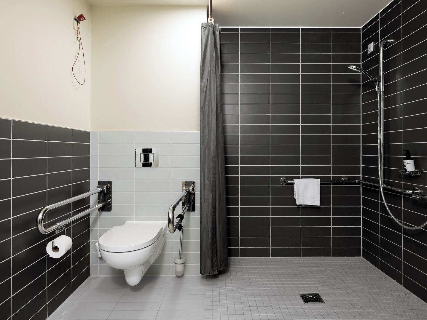 A modern bathroom with a toilet, bidet, and shower.