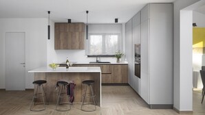 A modern kitchen with a central island, bar stools, wooden cabinets, and a large window. - Lovely Villa Arman with a pool and a jacuzzi (Vizinada)