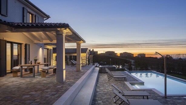 A poolside area with a pergola, outdoor seating, and a view of the sunset. - Lovely Villa Arman with a pool and a jacuzzi (Vizinada)