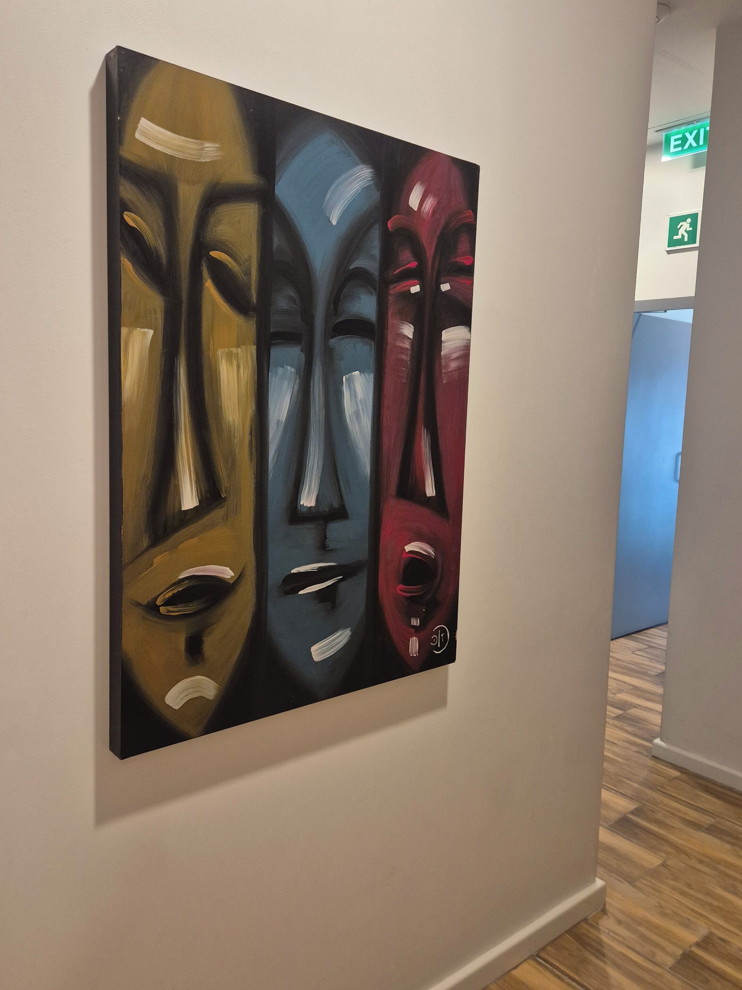 A painting on a wall in a hallway.