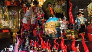 A display of various figurines and masks, likely part of a cultural exhibit or shop. - Baubo - S. G. Armeno by Napoliapartments (Naples)
