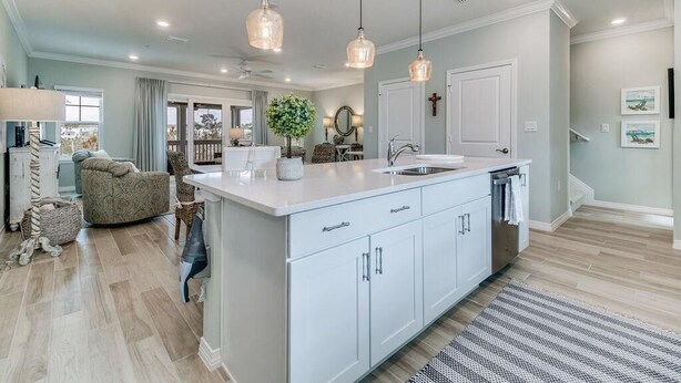 A spacious kitchen with a large island, pendant lighting, and a view to the dining area. - Beaches and Birdies, Lost Key Golf and Beach Resort (Pensacola)