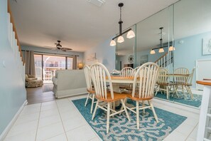Enjoy meals in this spacious dining area with a wooden table and comfortable seating for all.