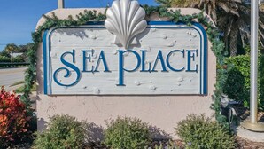 A sign with the words "SEA PLACE" and a shell decoration. - Ocean view townhouse with pools, tennis and so much more! SP 12230 (St. Augustine Beach)
