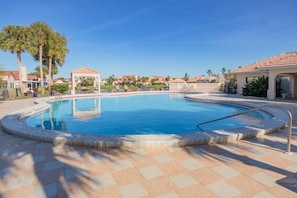 A swimming pool with a tiled deck, palm trees, and a gazebo. - Ocean view townhouse with pools, tennis and so much more! SP 12230 (St. Augustine Beach)