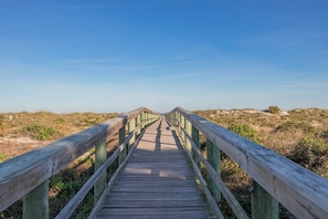 A wooden boardwalk leading to a beach with dunes and clear skies. - Ocean view townhouse with pools, tennis and so much more! SP 12230 (St. Augustine Beach)