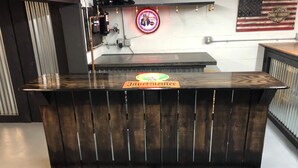 A bar counter with a neon sign, a Harley-Davidson flag, and a Jägermeister bottle. - Cozy camp located in Elk County adjoining state game land. (Byrnedale)