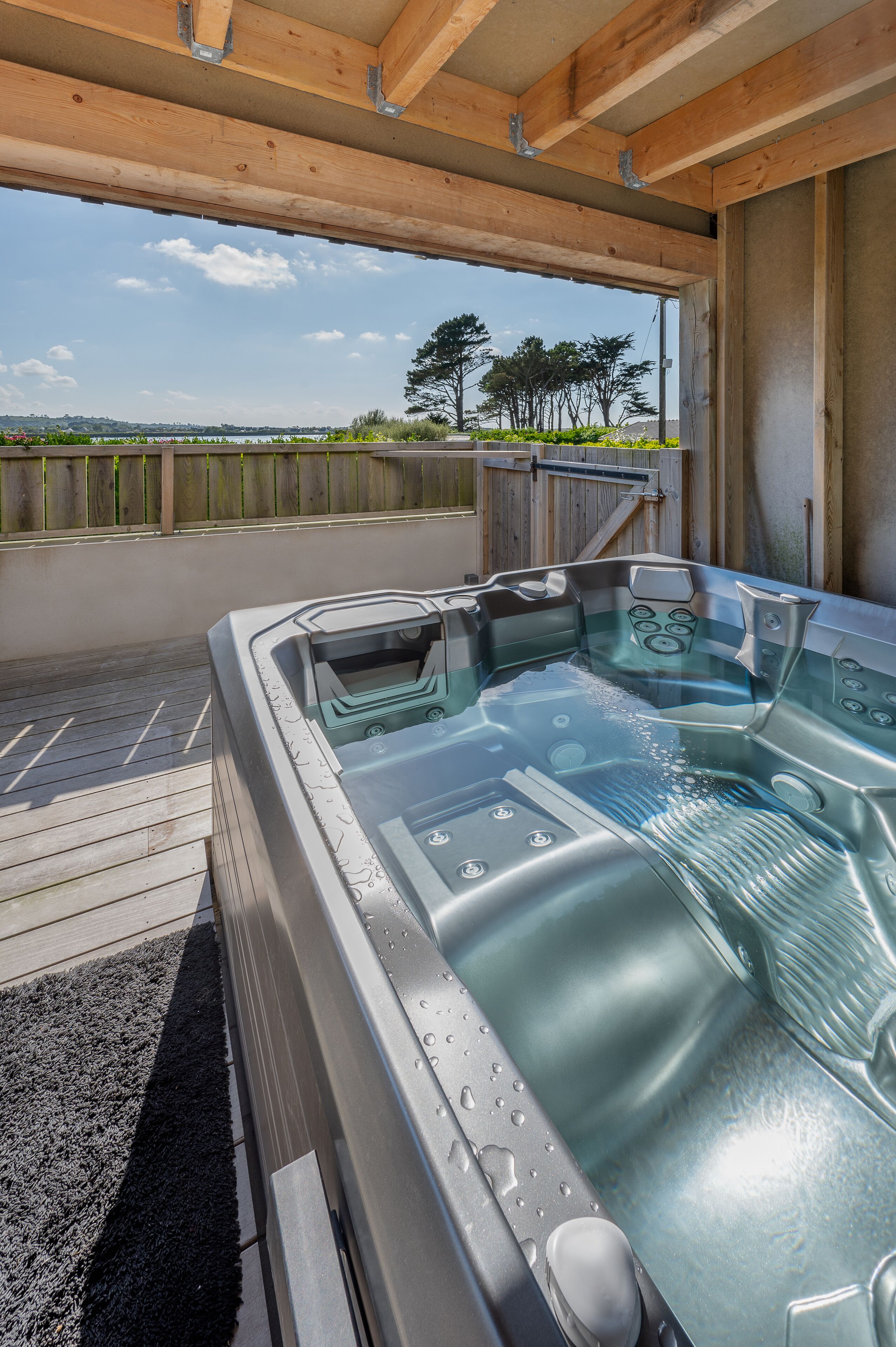 A hot tub with a view of the countryside.