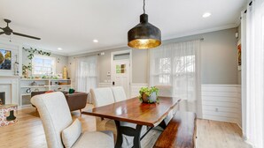 A dining area with a wooden table, chairs, and a hanging light fixture. - Incline Heights Haven - St Elmo District,  Chattanooga (Chattanooga)
