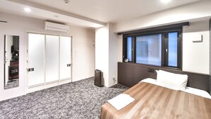 A hotel room with a bed, a window, a wardrobe, and a small desk. - Hotel Livemax Hakata-ekimae (Fukuoka)
